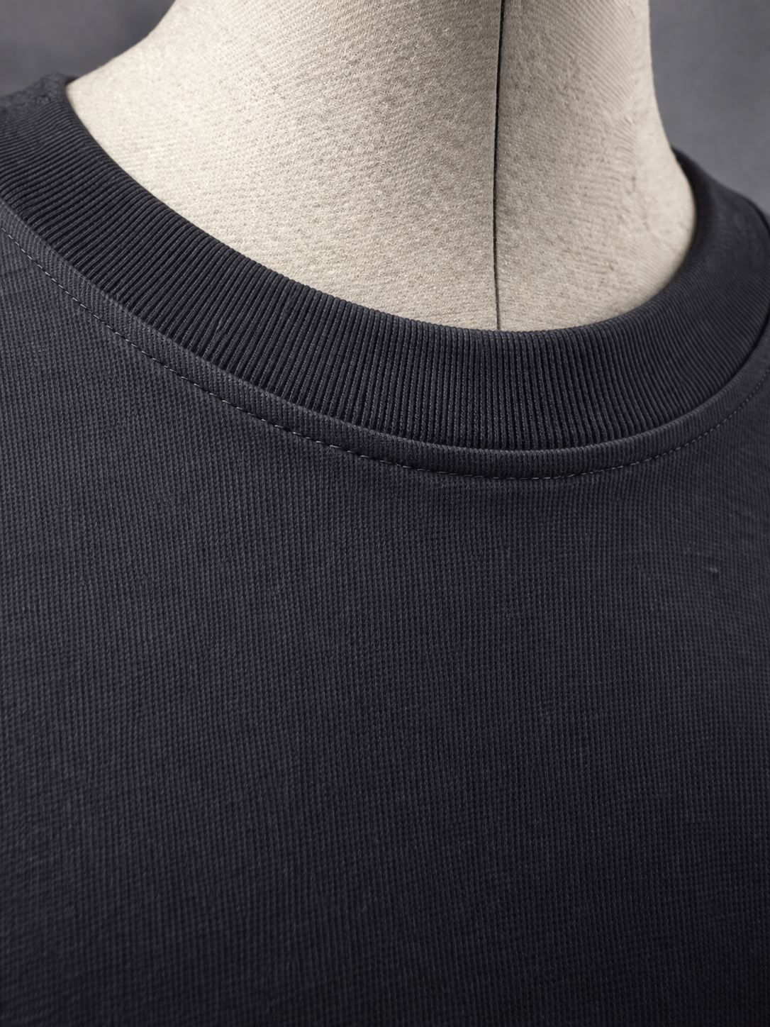 Close-up of ribbed collar and stitching on black 215 gsm organic cotton T-shirt, ARC Exhibit 01 Vector